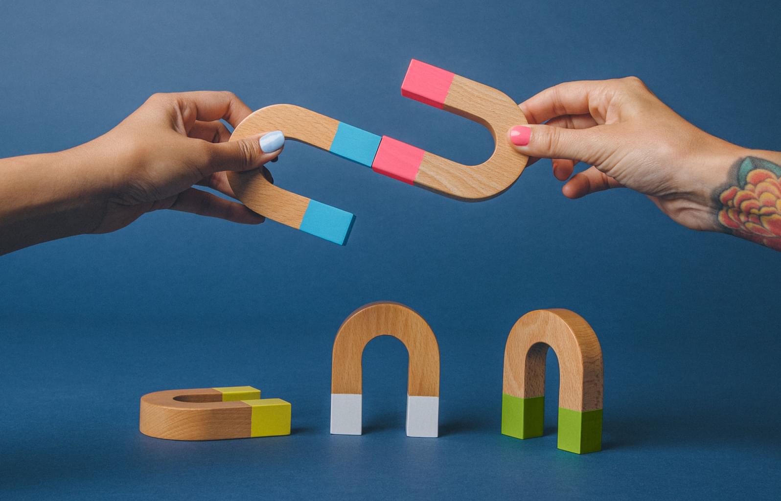 hands and u-shaped magnets coming together
