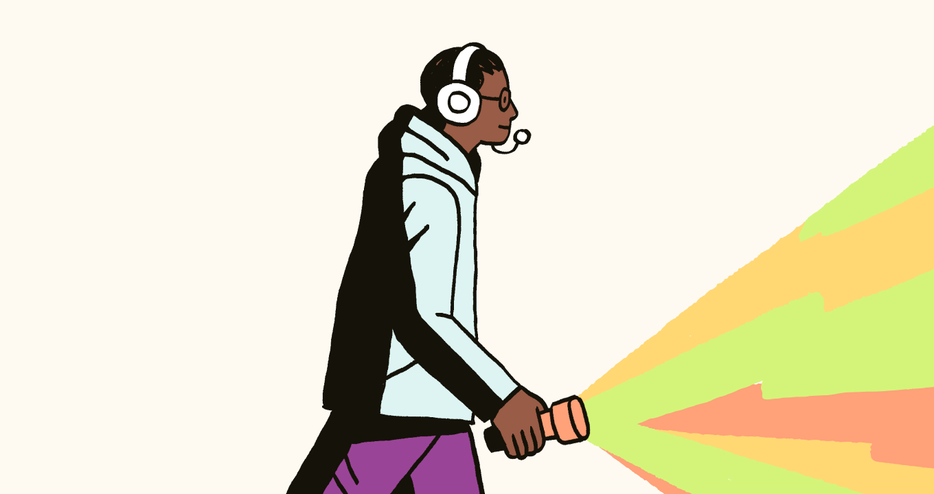 Person walking with headphones on and flashlight in hand
